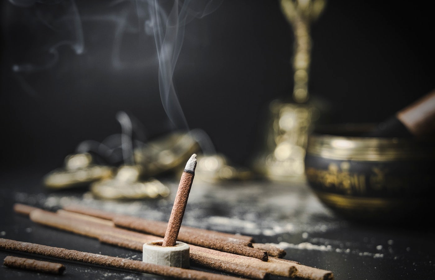 Incense smoke and brass ritual pieces for oud and bakhoor education